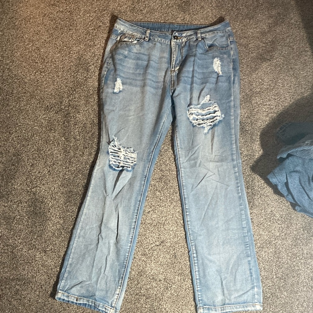 size large bootcut, holed jeans. embroidery on pocket.